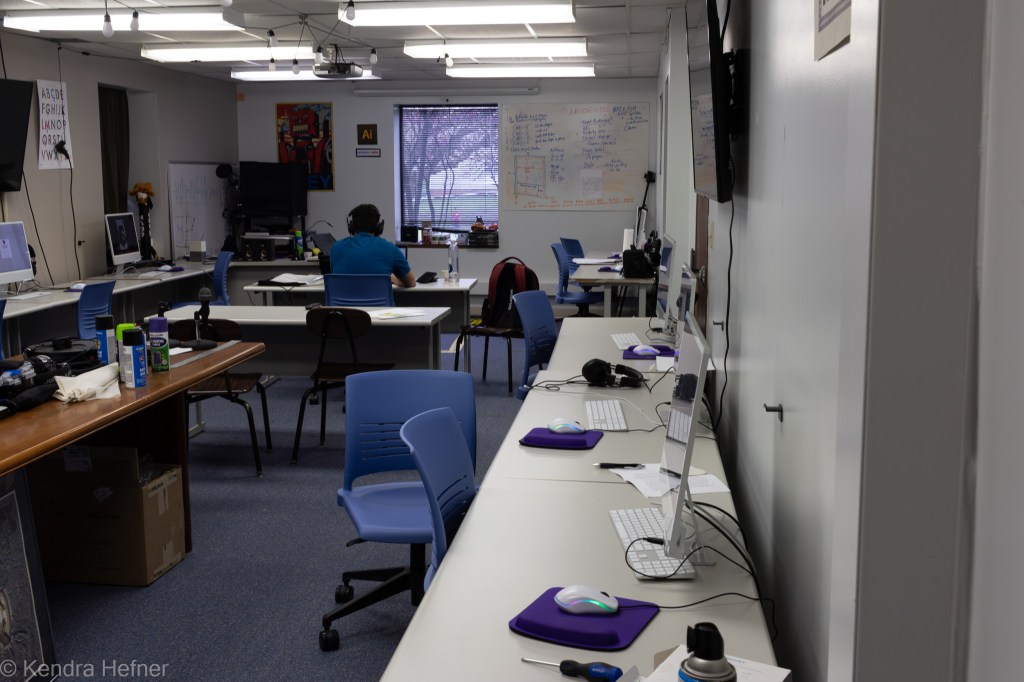 Bryce Gomes, IW Digital Media Design student from Perth, Australia, sitting alone completing homework assignments on his laptop in the Hershey West Mac lab. Spring 2023.
