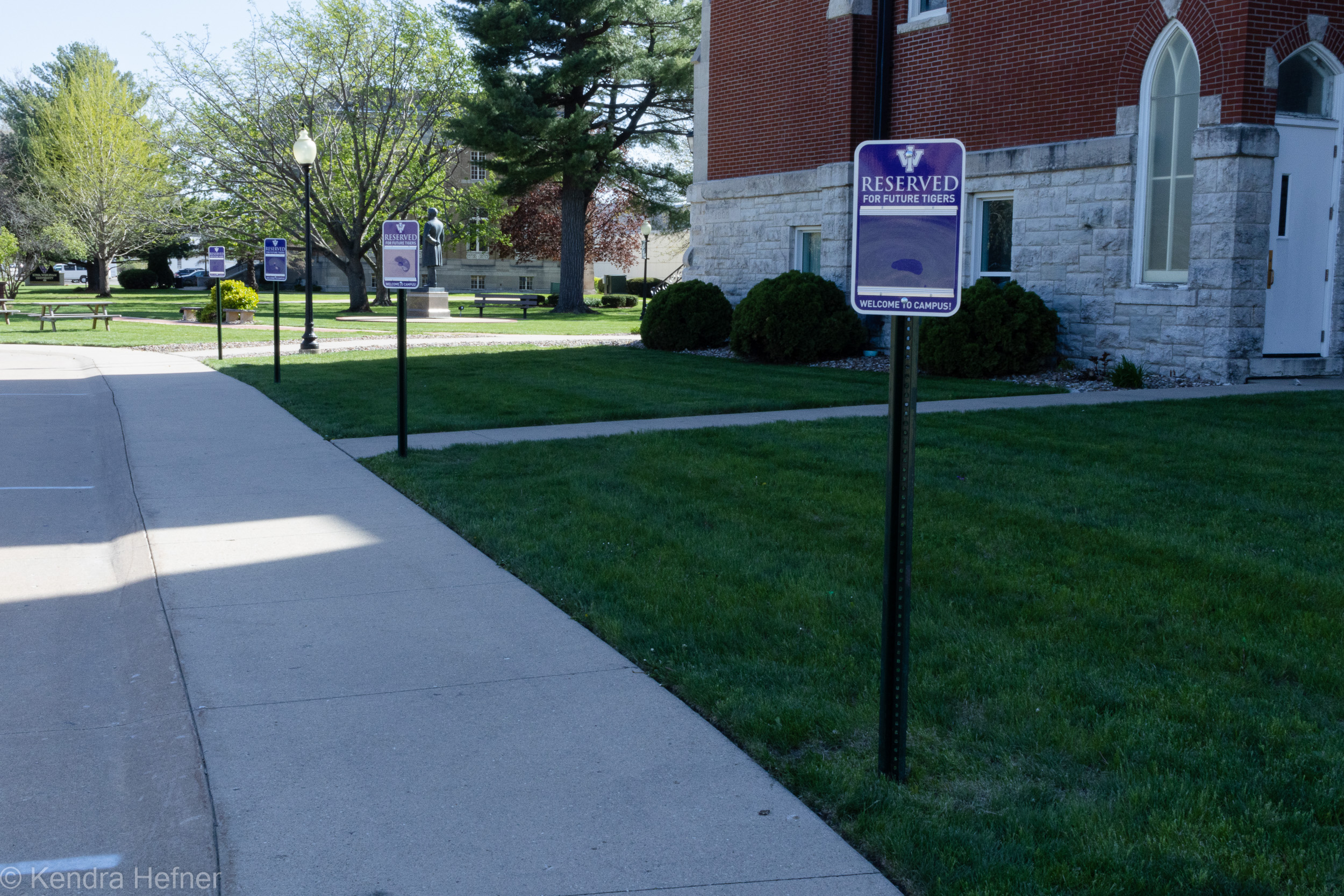 Reserved parking signs outside of the University Chapel, the building which housed Admissions. Spring 2023.